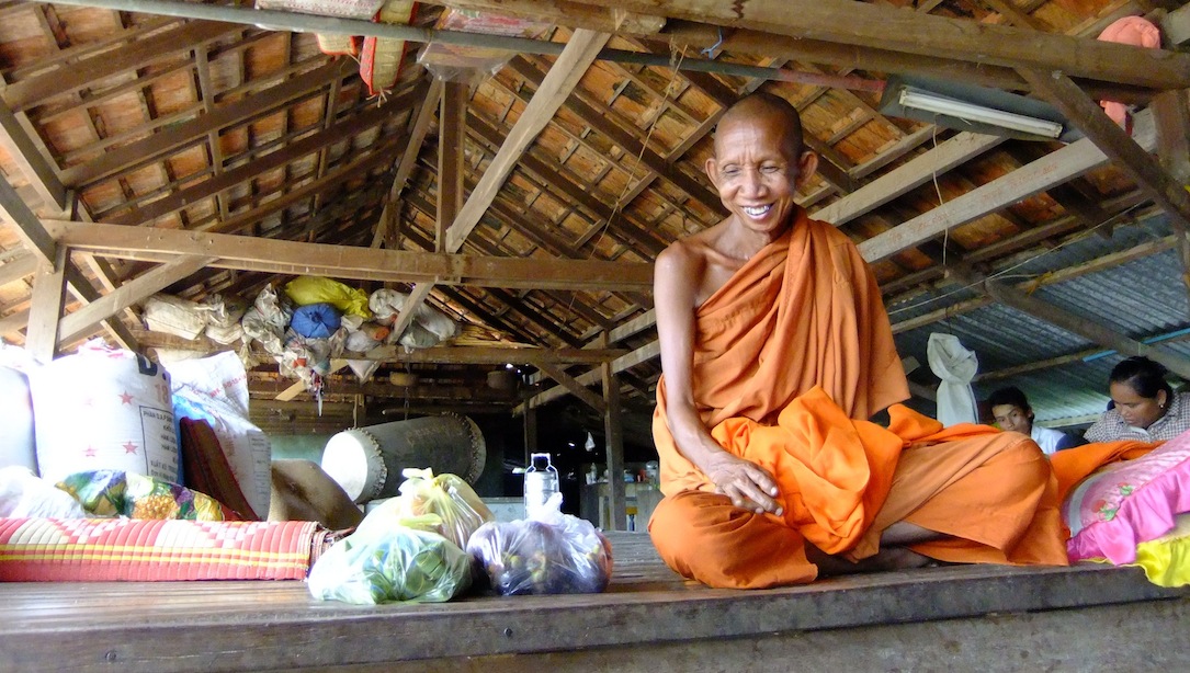 Venerable May Sokhan at Wat Pratheath, smiling at the numerous dogs that live at the pagoda with the monks. (Photo by Rothany Srun)